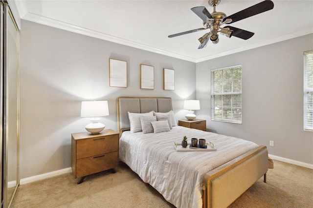 carpeted bedroom with crown molding and ceiling fan