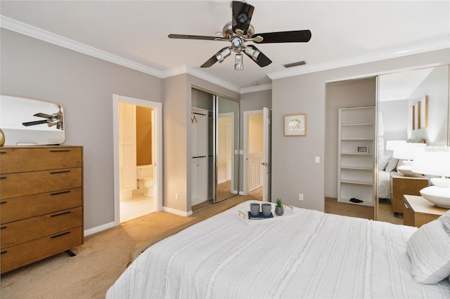 bedroom featuring ceiling fan, ensuite bath, ornamental molding, and light colored carpet