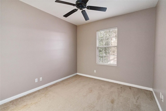 empty room featuring light carpet and ceiling fan