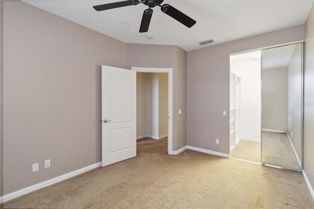 unfurnished bedroom featuring light colored carpet and ceiling fan