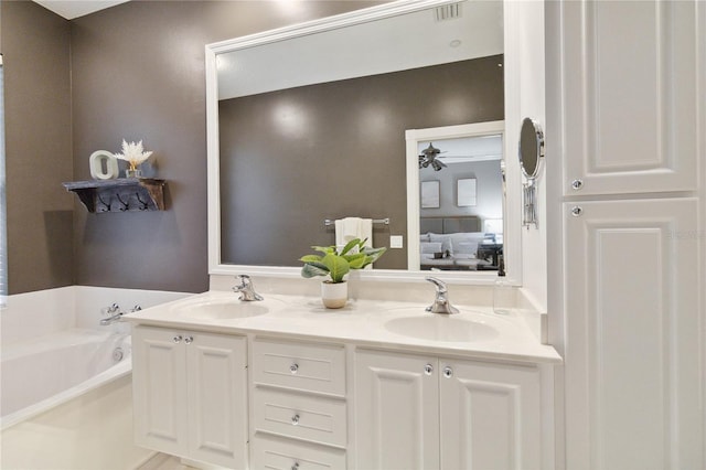 bathroom featuring a bathing tub, vanity, and ceiling fan