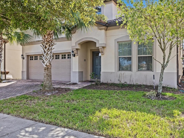 8832 Macapa Dr, Kissimmee, FL 34747 - mediterranean / spanish-style home featuring stucco siding, a garage, driveway, and a front lawn