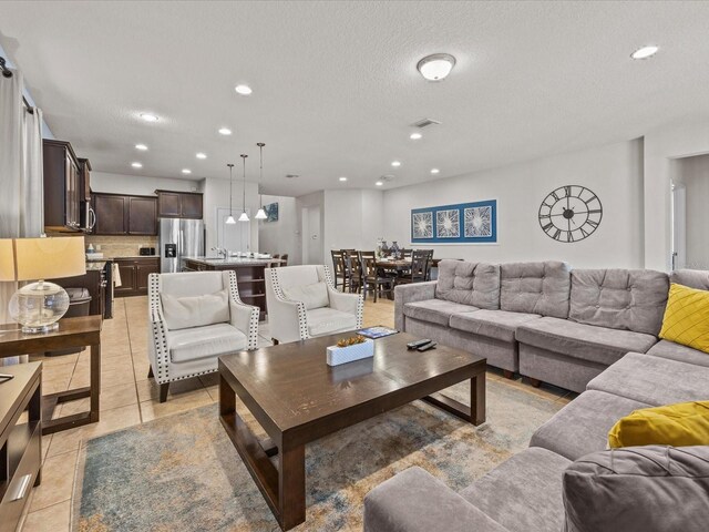 8832 Macapa Dr, Kissimmee, FL 34747 - living area featuring recessed lighting, light tile patterned floors, and a textured ceiling