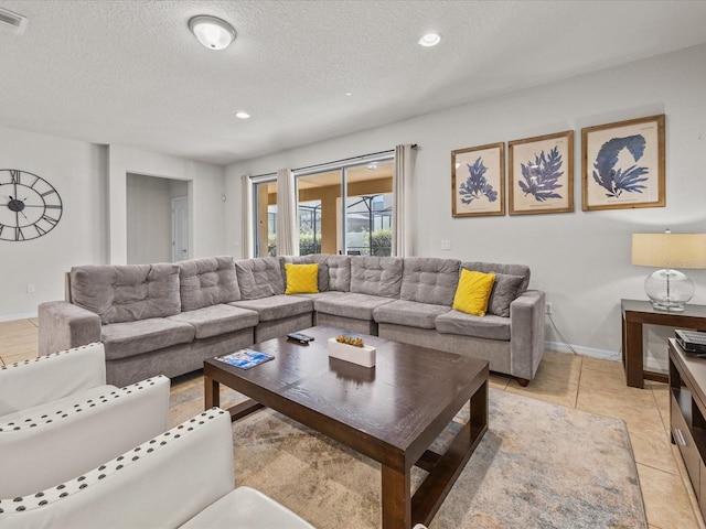 8832 Macapa Dr, Kissimmee, FL 34747 - living area featuring a textured ceiling, baseboards, light tile patterned floors, and recessed lighting