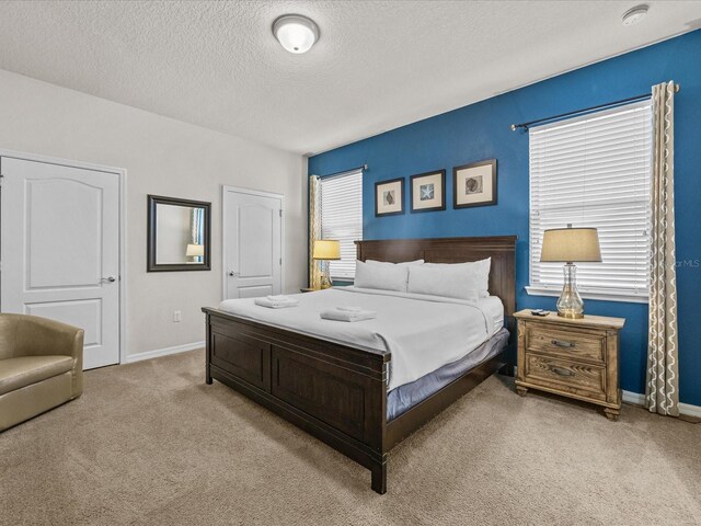 8832 Macapa Dr, Kissimmee, FL 34747 - carpeted bedroom featuring baseboards and a textured ceiling