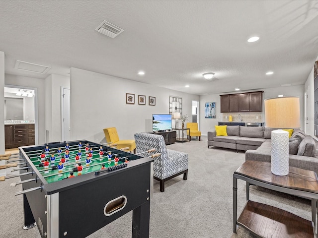 8832 Macapa Dr, Kissimmee, FL 34747 - game room with light carpet, recessed lighting, a textured ceiling, and attic access