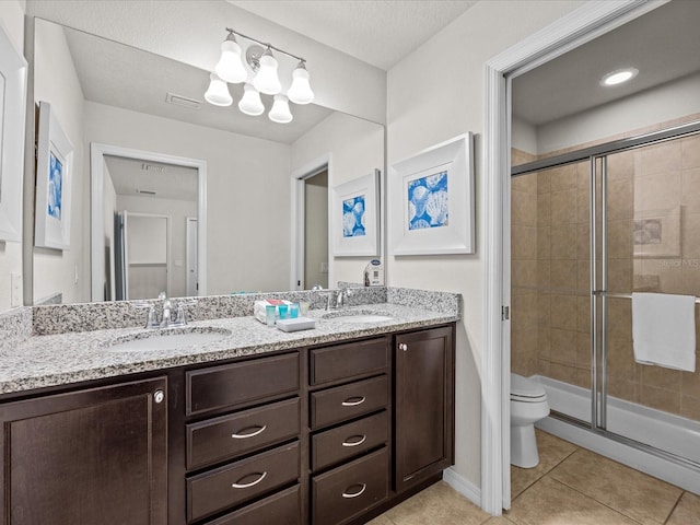 bathroom with a shower with door, toilet, tile patterned flooring, vanity, and a textured ceiling