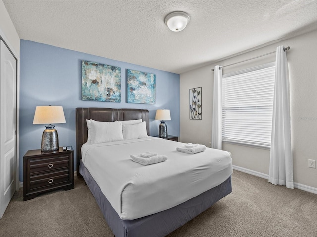 bedroom featuring carpet and a textured ceiling