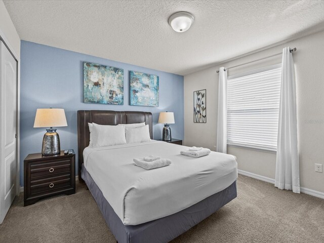 8832 Macapa Dr, Kissimmee, FL 34747 - bedroom featuring carpet flooring, a textured ceiling, and baseboards