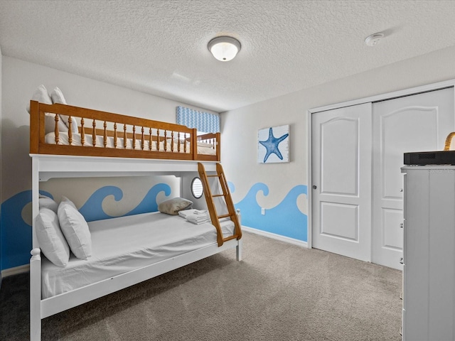 carpeted bedroom with a closet and a textured ceiling