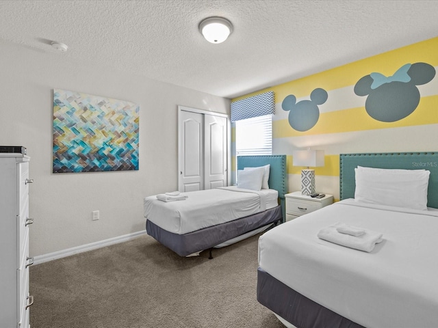 carpeted bedroom featuring a closet and a textured ceiling