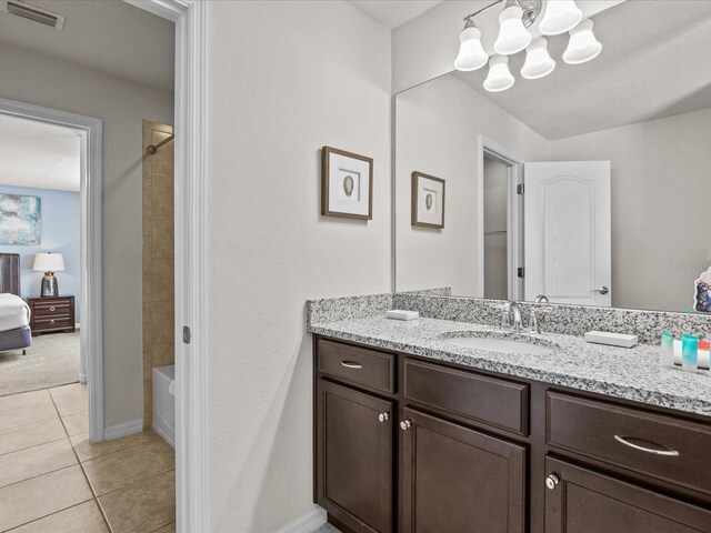 8832 Macapa Dr, Kissimmee, FL 34747 - bathroom with a chandelier, vanity, tile patterned floors, shower / bath combination, and baseboards