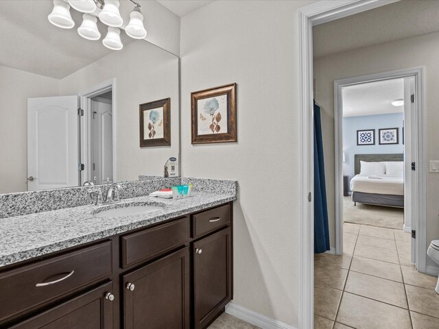 8832 Macapa Dr, Kissimmee, FL 34747 - ensuite bathroom with a chandelier, vanity, baseboards, and tile patterned flooring