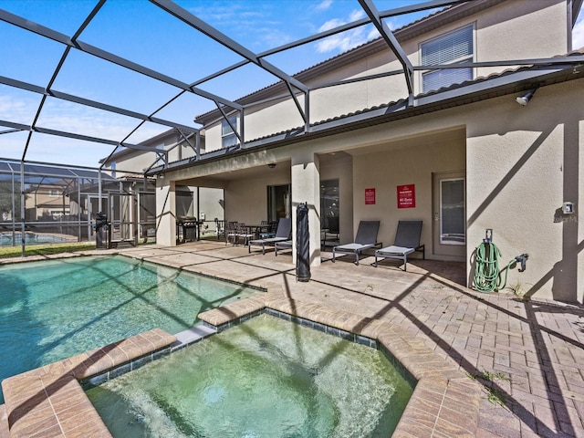 view of pool featuring a patio, a lanai, and an in ground hot tub