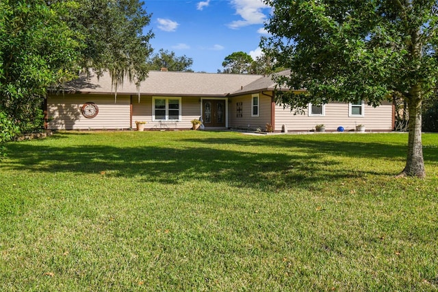 rear view of house with a lawn