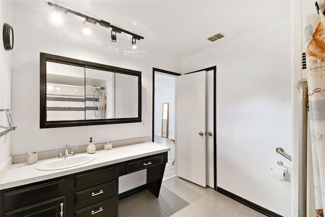 bathroom with vanity, a shower with curtain, and tile patterned flooring