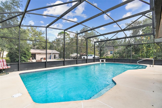 view of swimming pool with a patio and a lanai