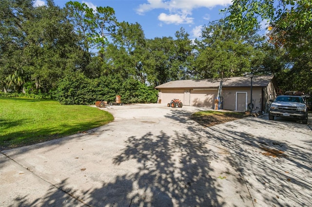 view of property exterior featuring a garage, driveway, and a yard