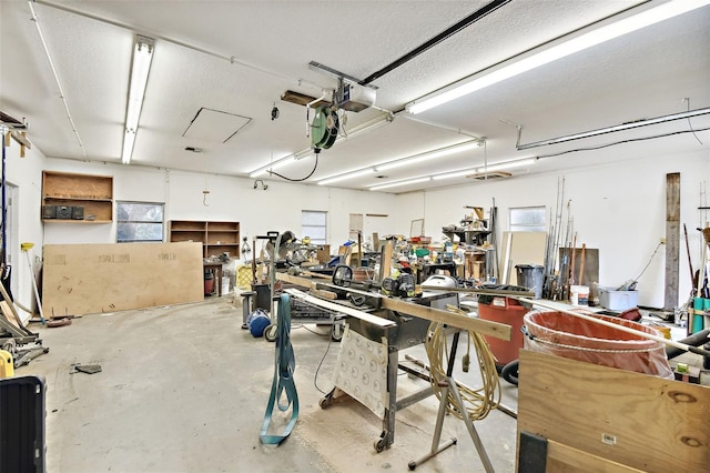 garage with a workshop area and a garage door opener