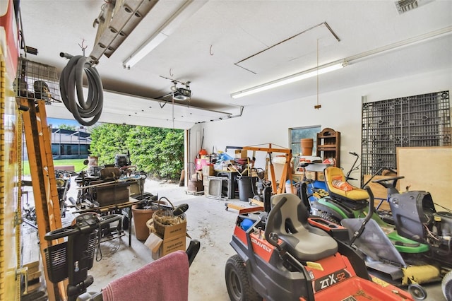 garage with visible vents and a garage door opener