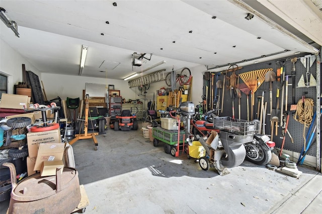 garage with a workshop area and a garage door opener