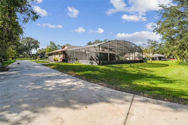 exterior space featuring a lawn and a lanai