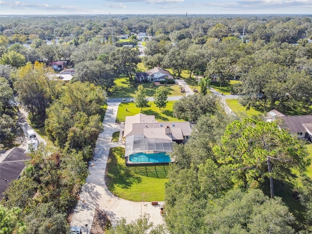 birds eye view of property featuring a wooded view