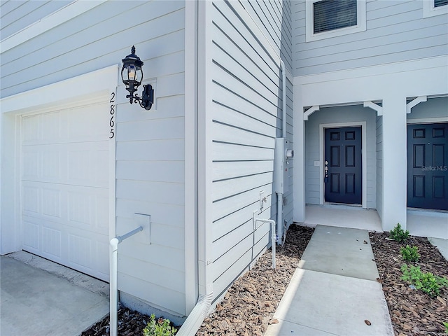 doorway to property with a garage