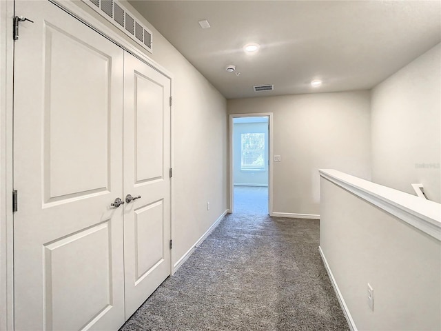 hallway with dark carpet