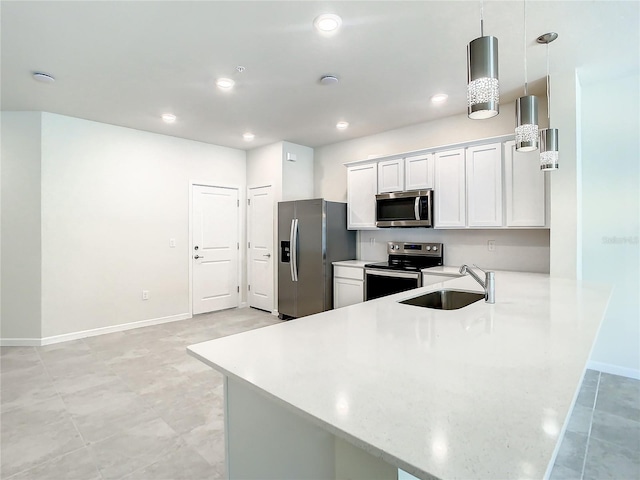 kitchen with kitchen peninsula, white cabinetry, sink, pendant lighting, and stainless steel appliances