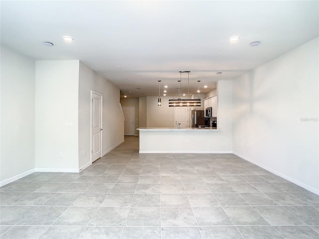 unfurnished living room with light tile patterned floors