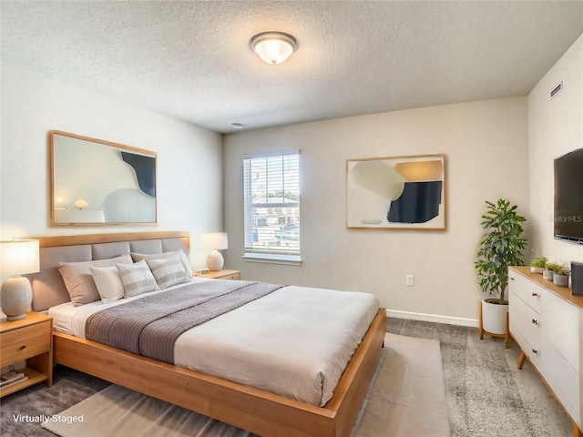 carpeted bedroom with a textured ceiling