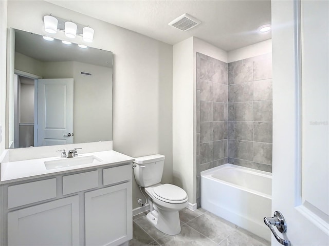 full bathroom featuring toilet, tiled shower / bath combo, vanity, and tile patterned floors