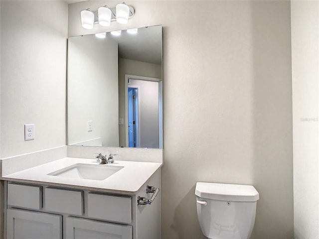 bathroom featuring toilet and vanity