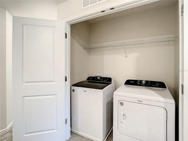 clothes washing area with washing machine and clothes dryer