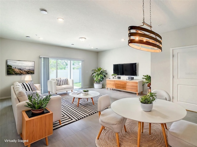 living room with a chandelier, recessed lighting, and baseboards