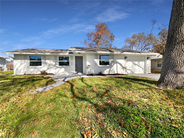 ranch-style house featuring a front yard and a garage