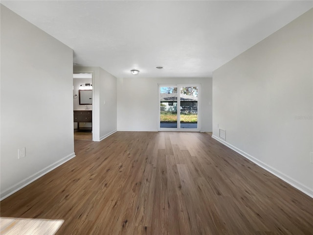 empty room featuring dark hardwood / wood-style flooring