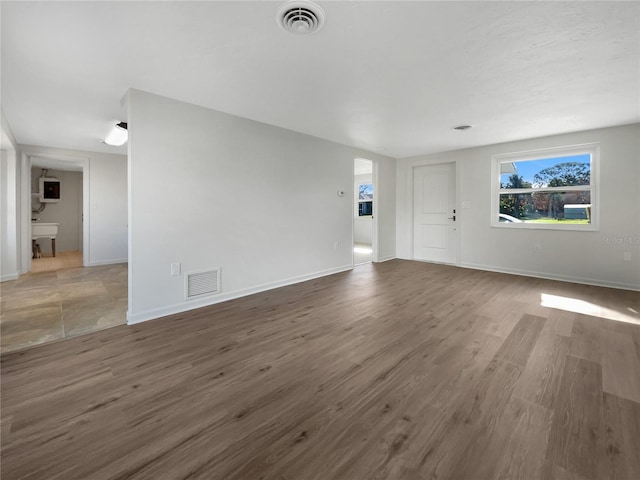 unfurnished living room featuring dark hardwood / wood-style floors