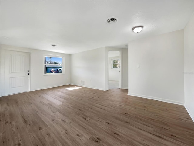 unfurnished living room featuring dark hardwood / wood-style flooring