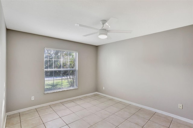 spare room featuring light tile patterned flooring and ceiling fan