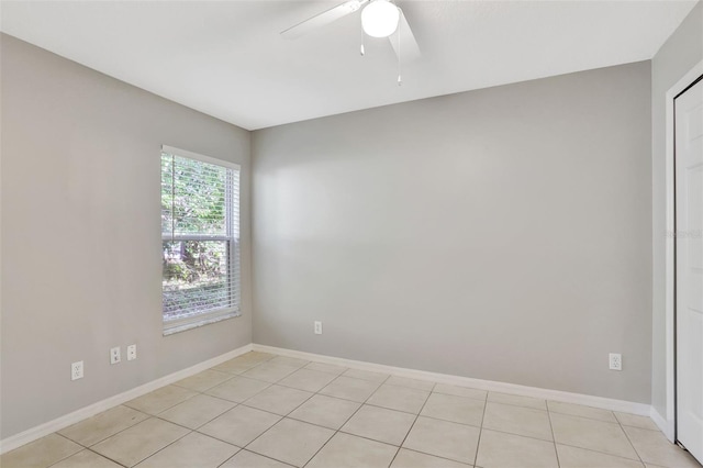 tiled empty room with ceiling fan