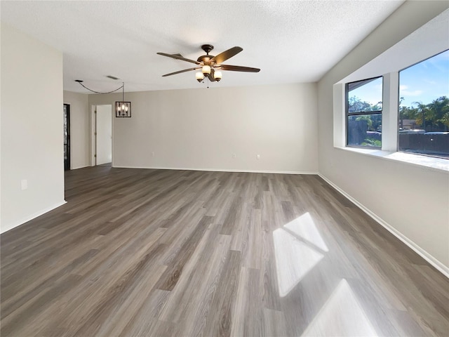 unfurnished living room with ceiling fan, wood-type flooring, and a textured ceiling