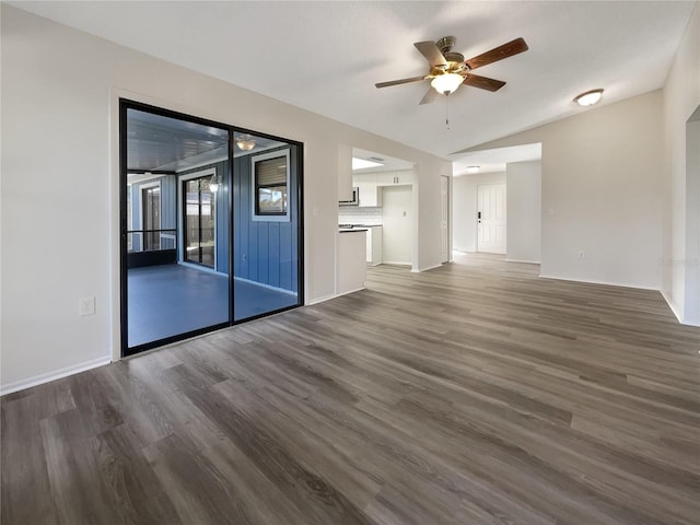 unfurnished living room with dark wood-type flooring, ceiling fan, and lofted ceiling