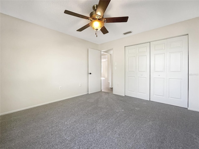 unfurnished bedroom with a textured ceiling, a closet, and ceiling fan