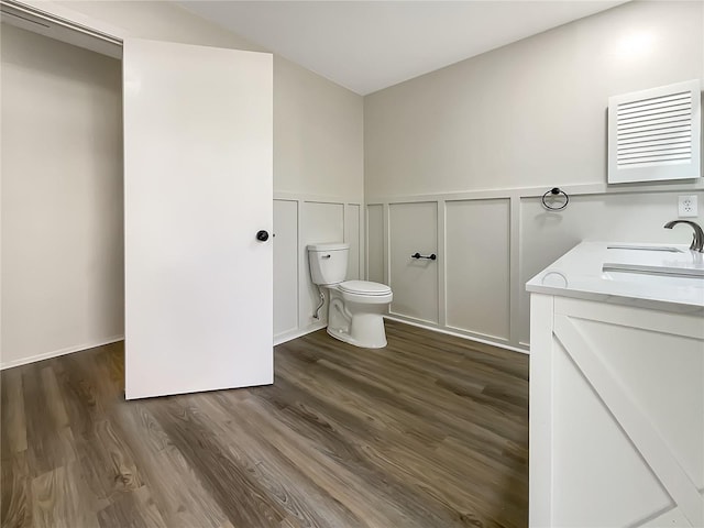 bathroom with vanity, hardwood / wood-style floors, and toilet