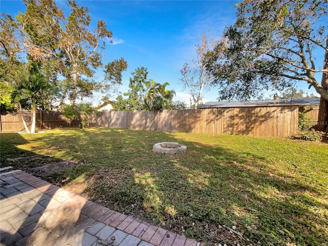 view of yard with a fire pit