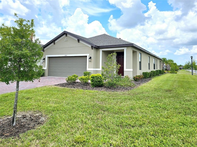 single story home featuring a front lawn and a garage