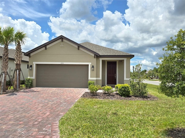 view of front of property with a front yard and a garage