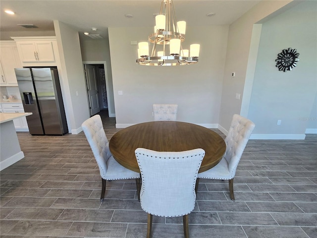 dining room featuring dark wood-type flooring and a notable chandelier